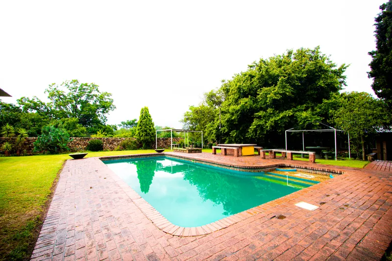 Pool area with lush greenery
